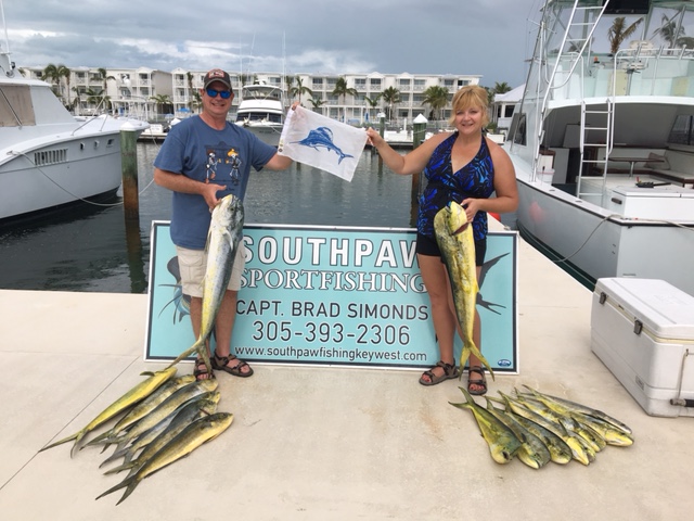 Couple posing with fresh caught mahi mahi