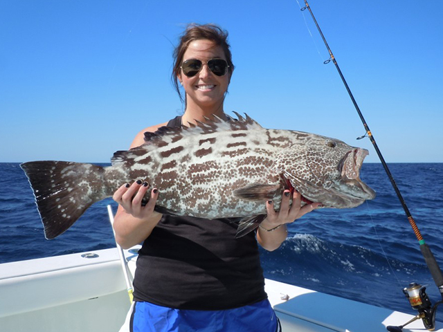 Woman holding a nice black grouper