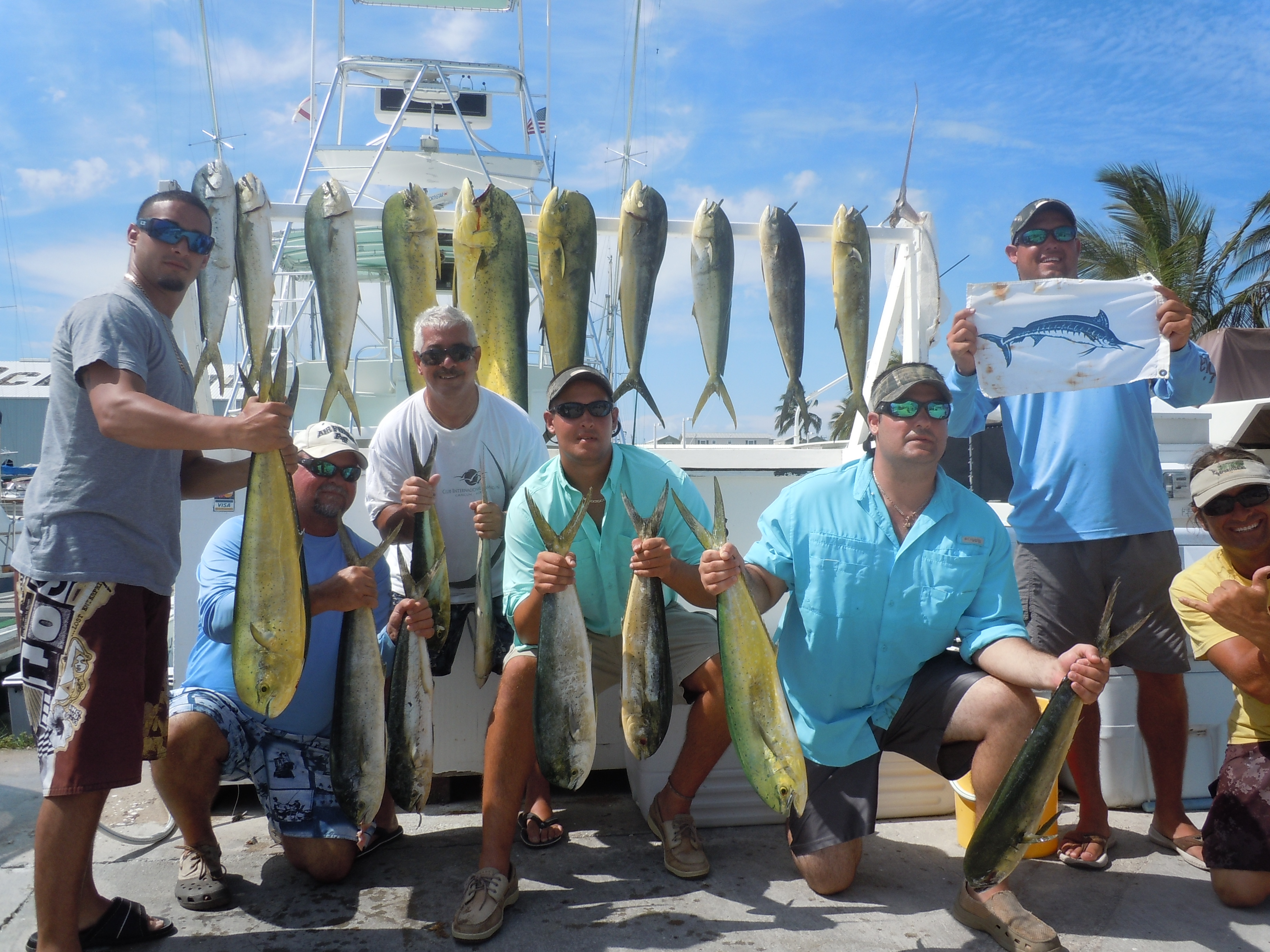7 men holding fish from a key west fishing charter