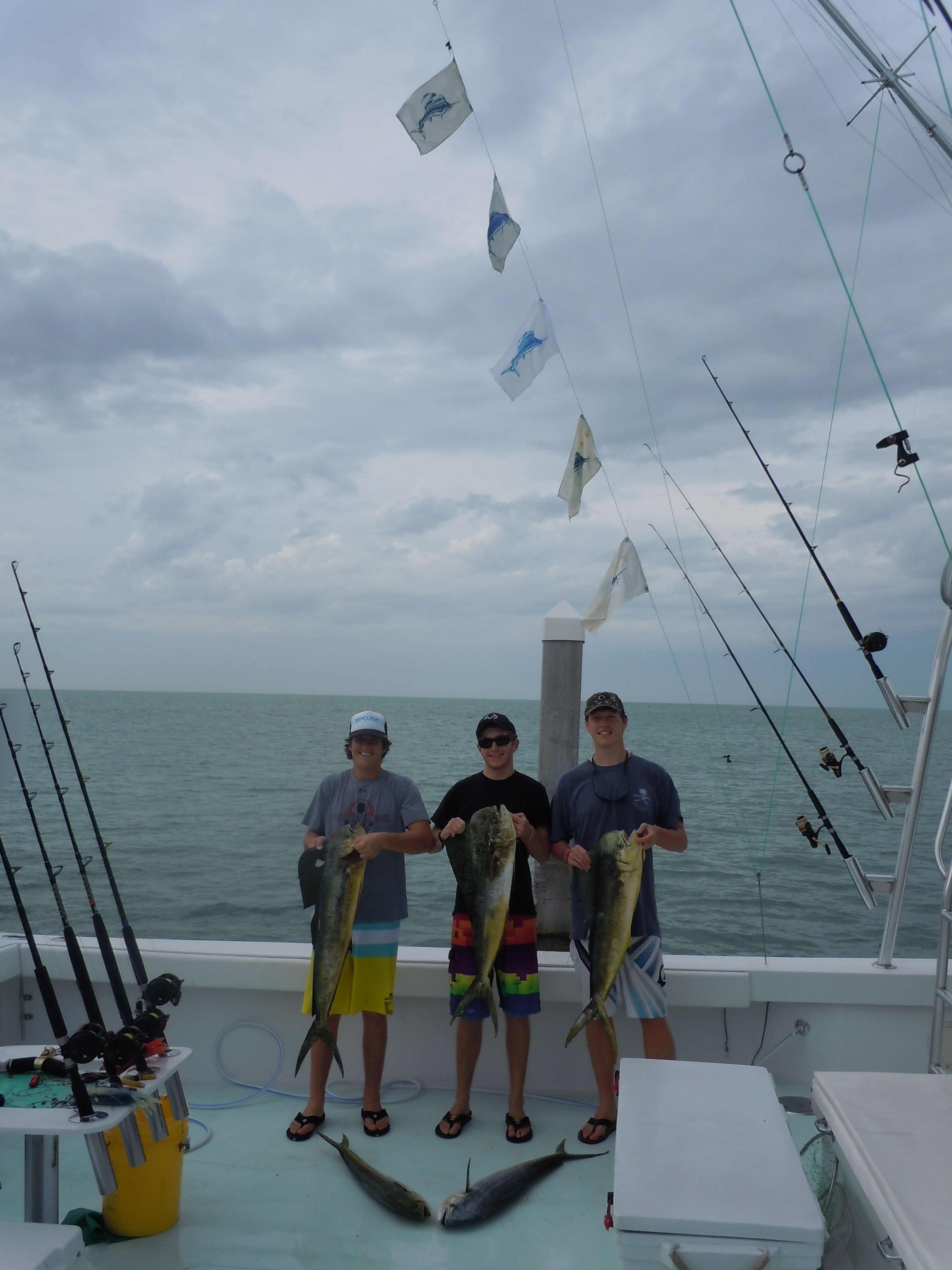 3 men with 5 catch and release flags and 5 dolphins