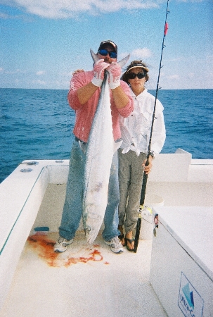 Fishing mate holding king fish