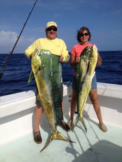 A couple with their dolphin catch