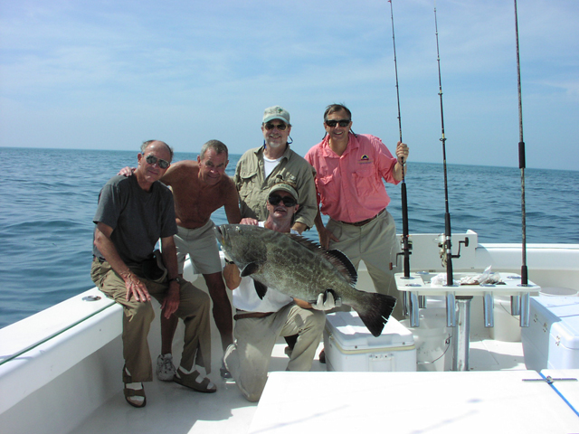 Fishing charter holding a black grouper