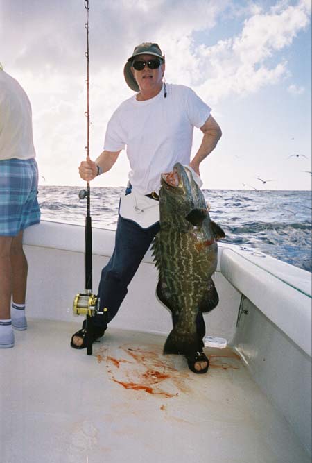 Man holding black grouper in Key West waters