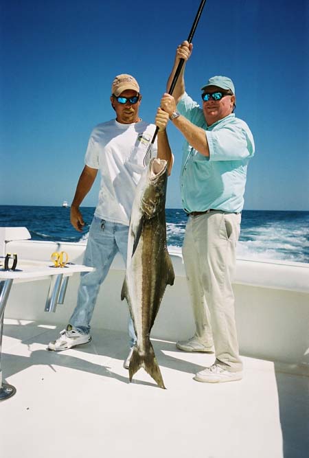 2 men holding a cobia in Key West waters