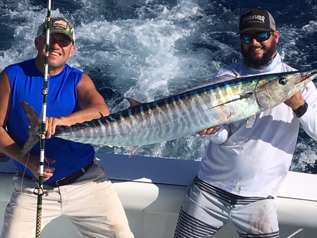 Fishing mate and guest holding a nice wahoo